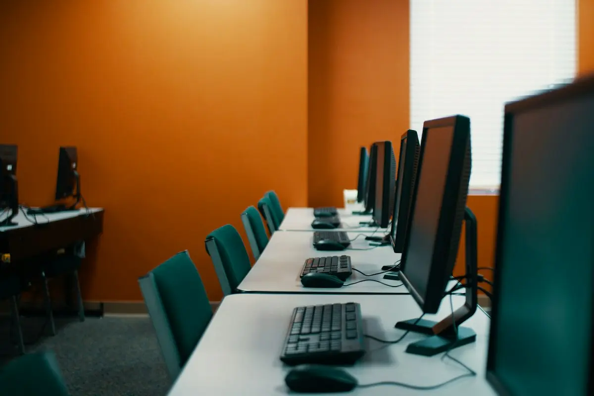 Row of desks with new computer workstations set up in an office